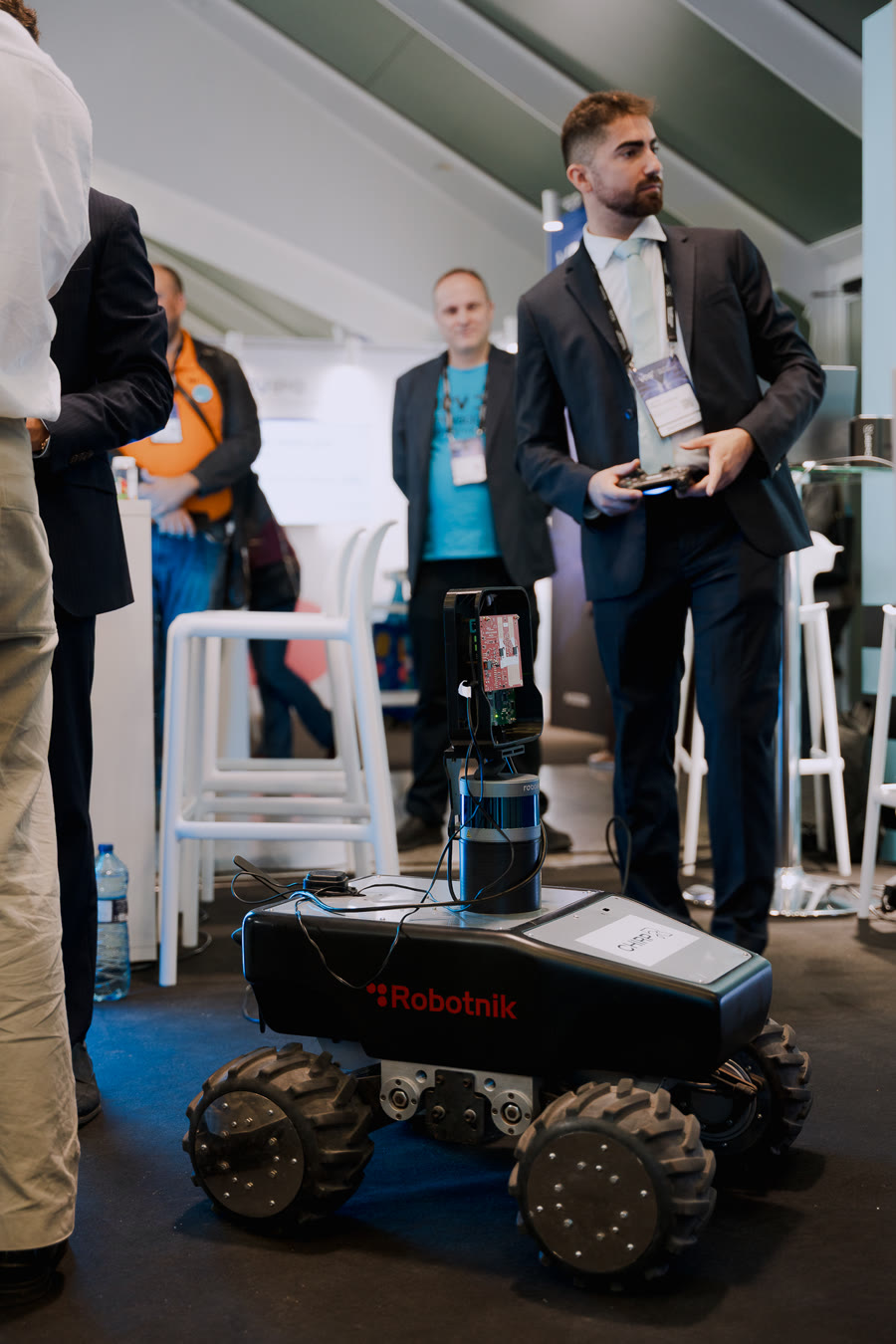 A CHIRP team member driving the HAWK rover with a remote controller on the stand